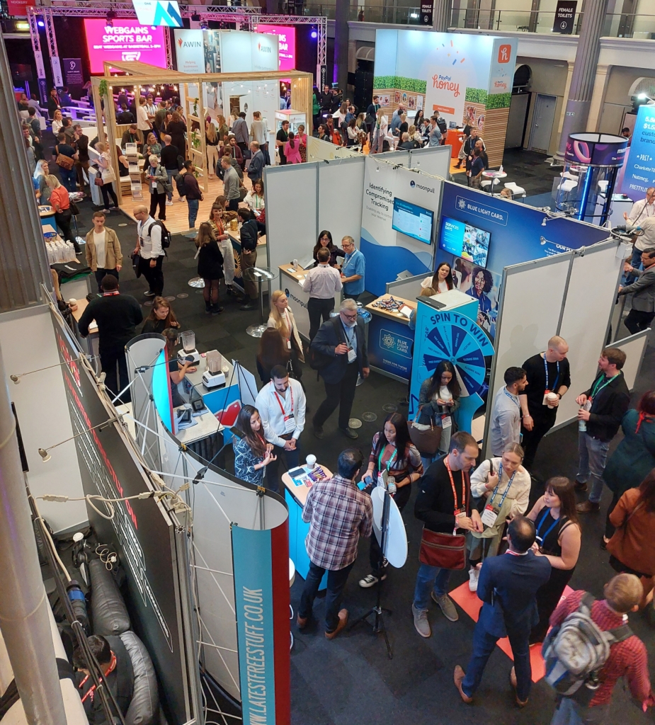 People talking on the exhibit floor.