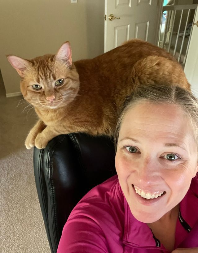 Me working, with my cat, Gracie “helping” me — another perk of the job!