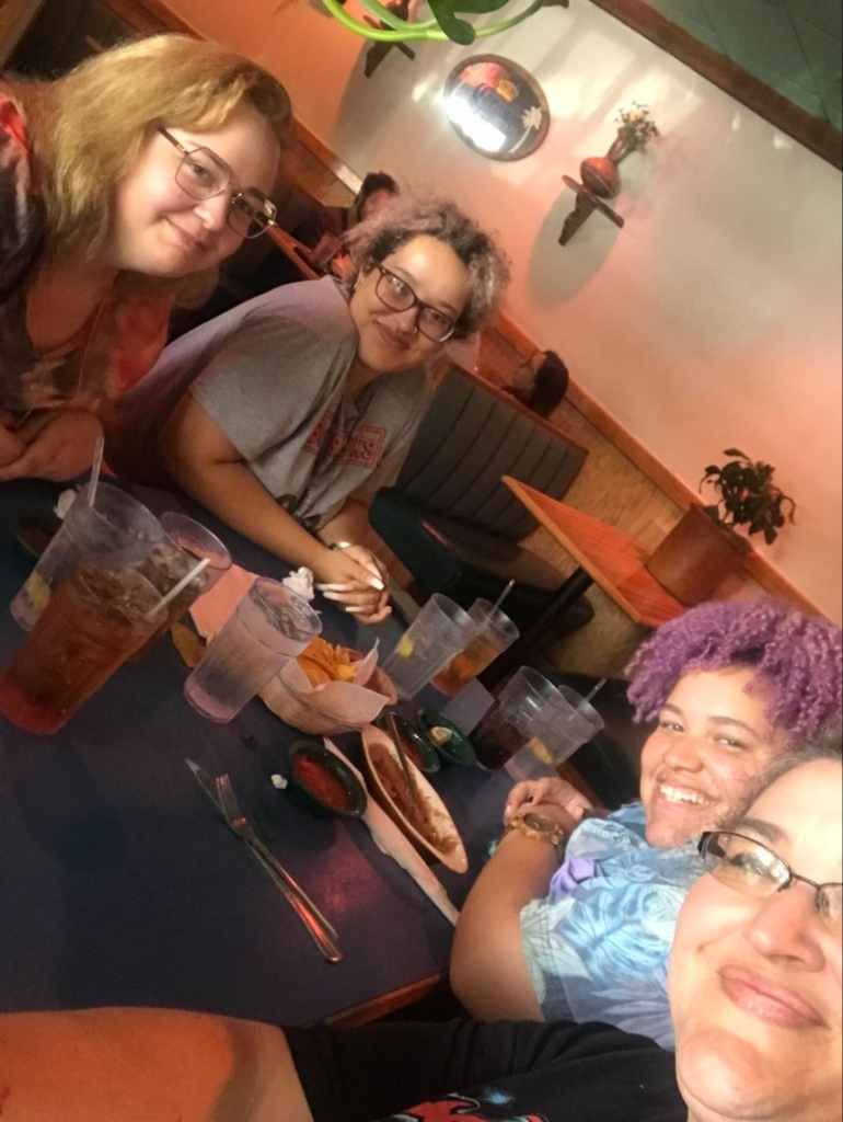 Heather Moor and daughters Storm, Camryn, and Carrigan sitting down for a meal.